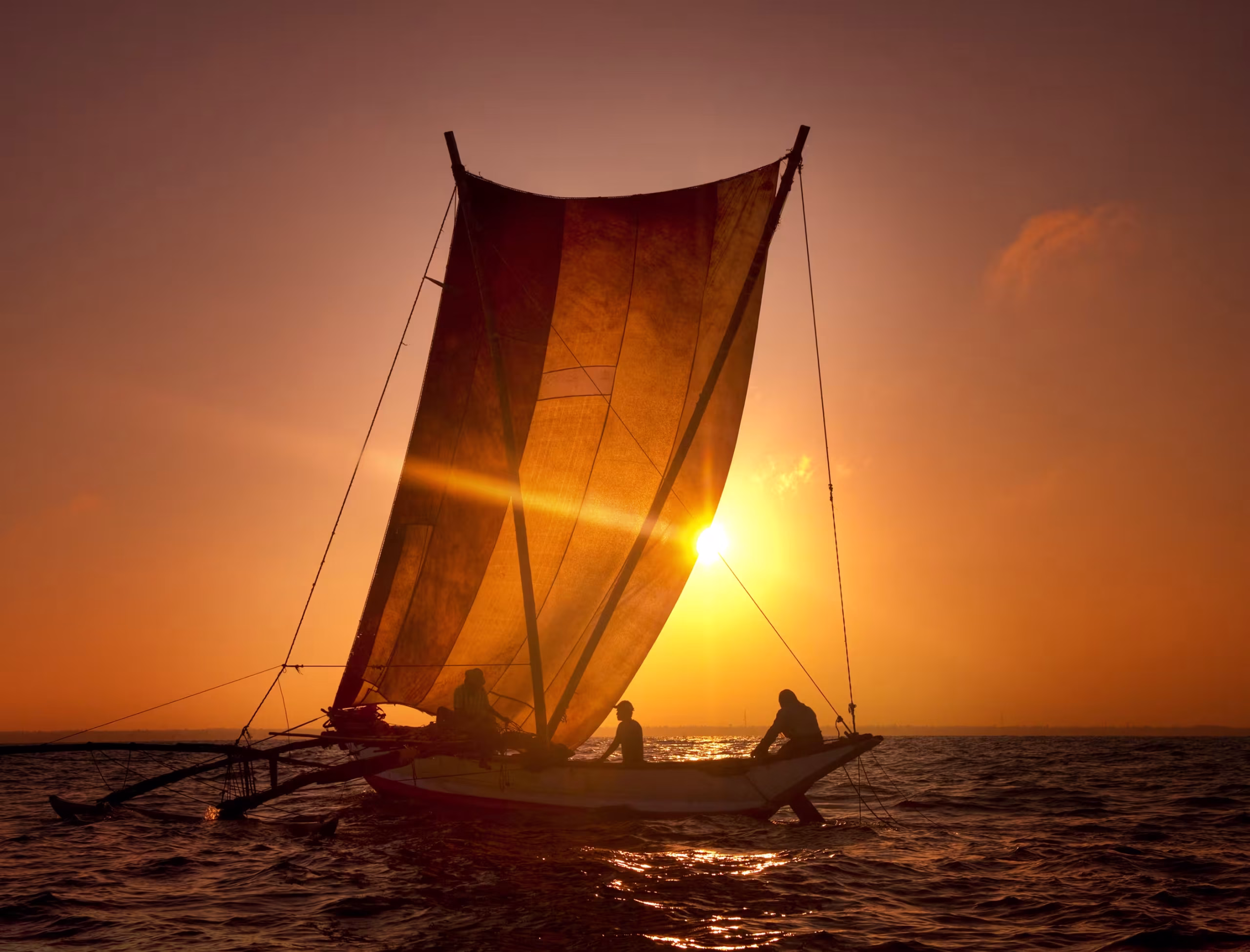 A dhow sailing at sunset off Zanzibar